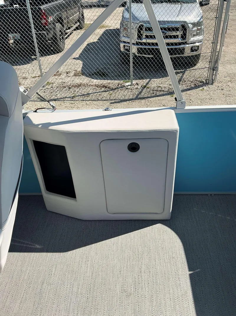 Slide: The Image of Interior of 2025 Sweetwater 2286 CSE boat with storage compartment and seating. - 14