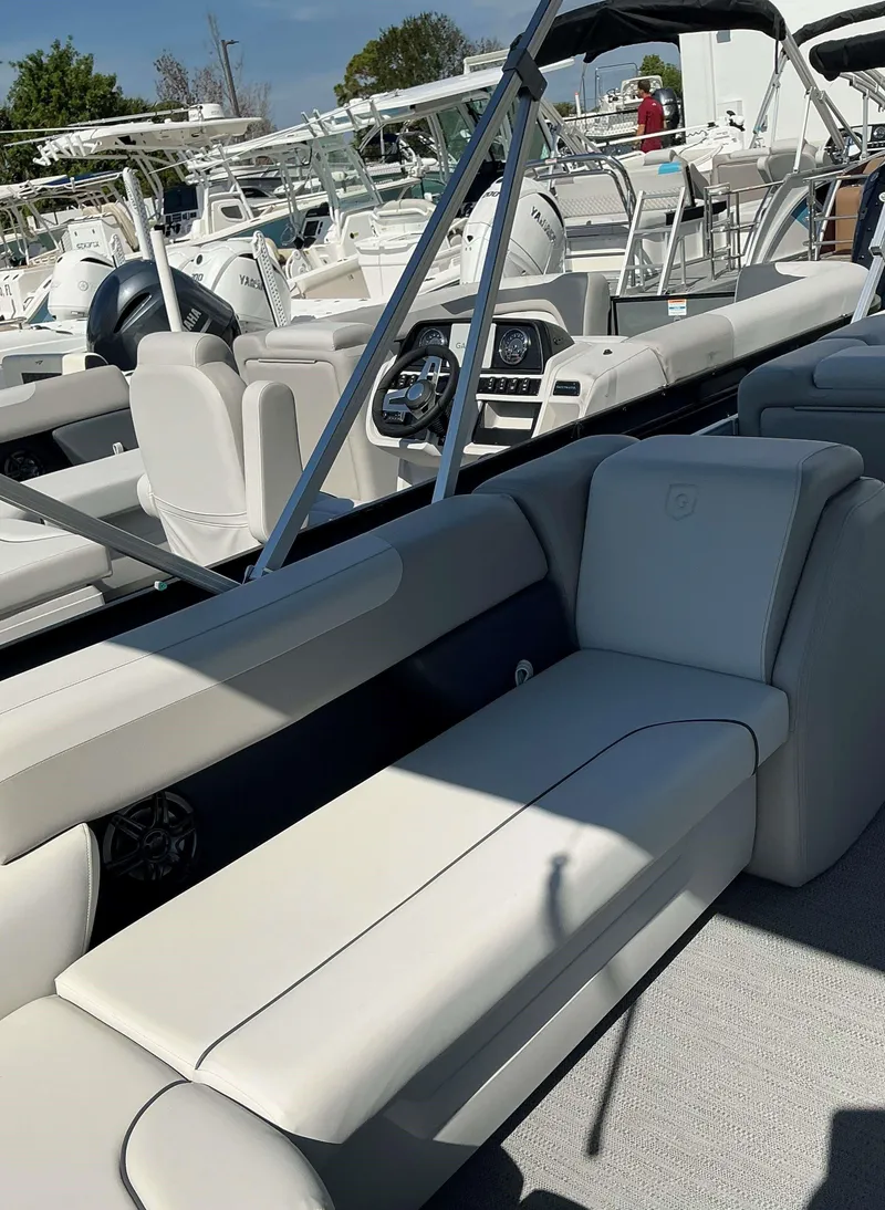 Slide: The Image of 2025 Sweetwater 2286 CSE boat interior with plush seating and modern dashboard. - 4