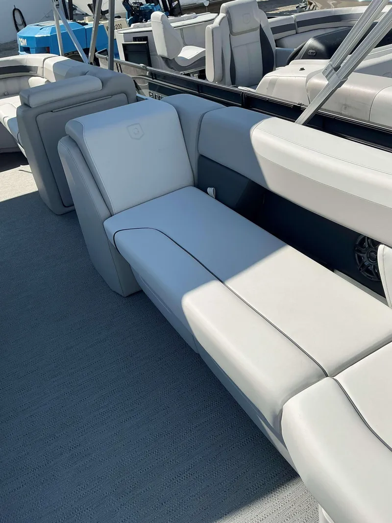 Slide: The Image of 2025 Sweetwater 2286 CSE boat interior with plush white seating and modern design. - 5