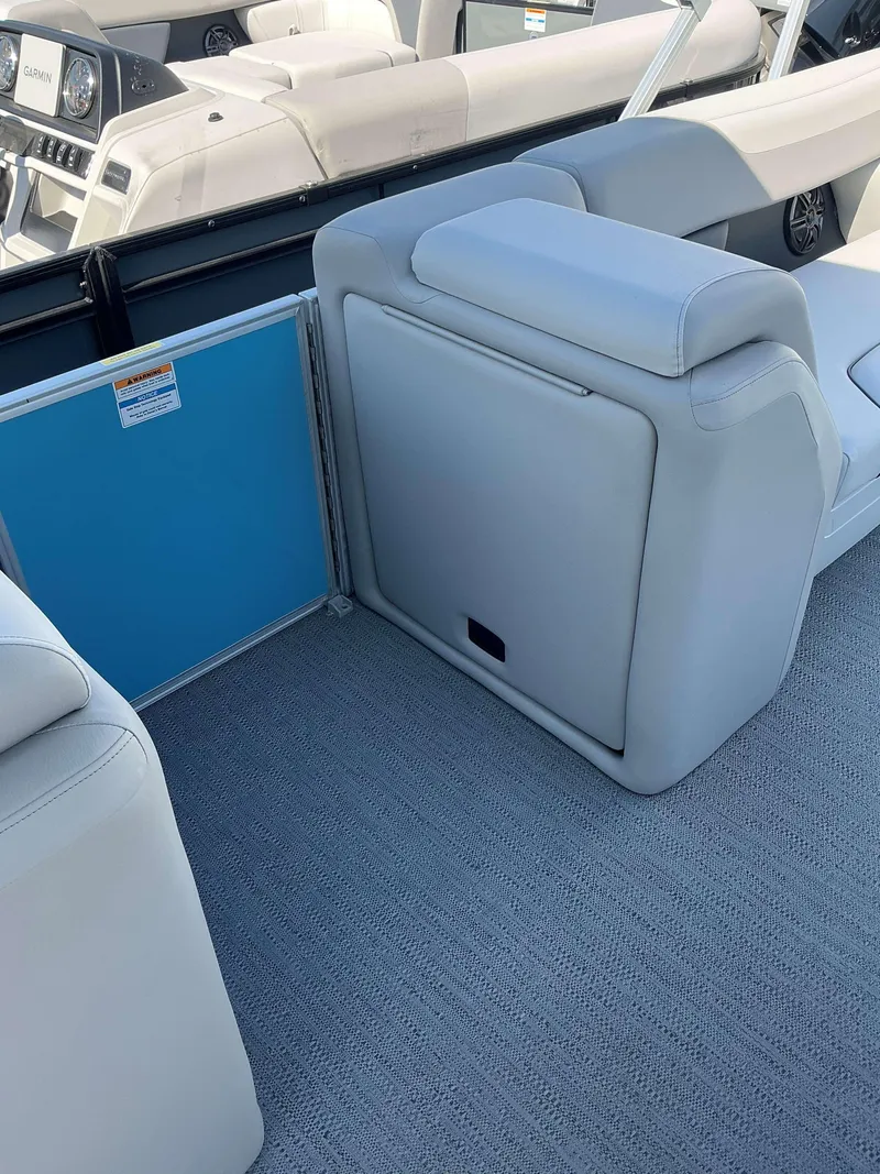 Slide: The Image of 2025 Sweetwater 2286 CSE boat interior with plush seating and modern design. - 6