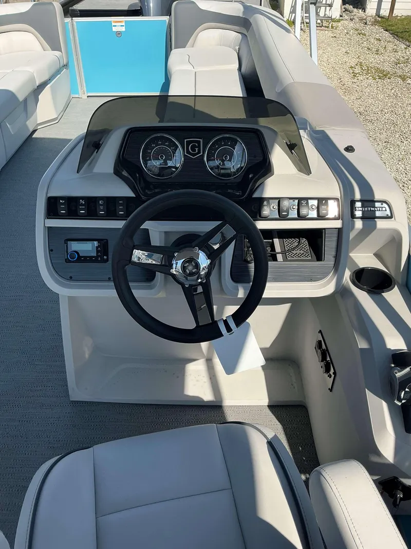 Slide: The Image of 2025 Sweetwater 2286 CSE boat interior with steering wheel and dashboard controls. - 8