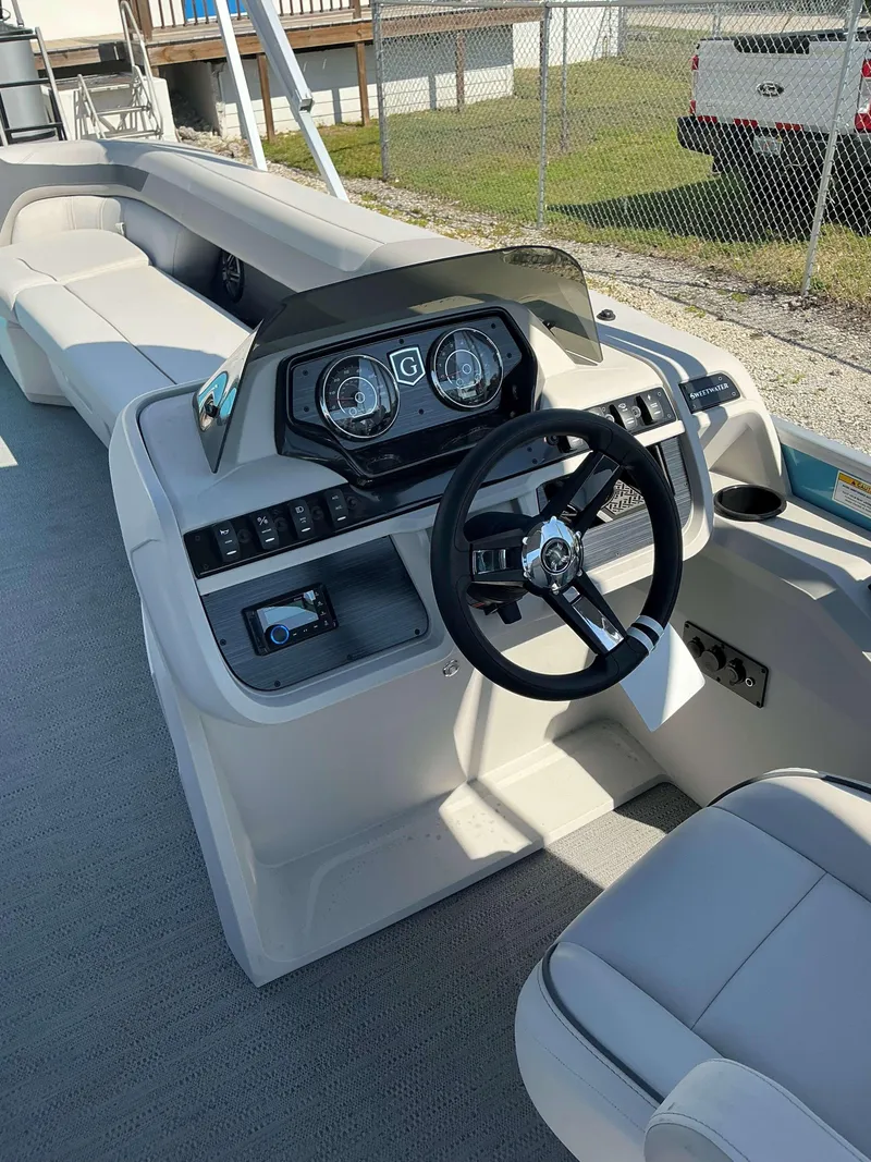 Slide: The Image of 2025 Sweetwater 2286 CSE boat interior with steering wheel and dashboard controls. - 9
