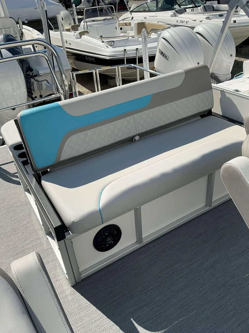 Slide: The Image of 2025 Sweetwater 2486 SFL boat interior with cushioned seating and modern design. - 11