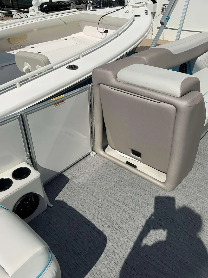 Slide: The Image of 2025 Sweetwater 2486 SFL boat interior with seating and storage compartments. - 14