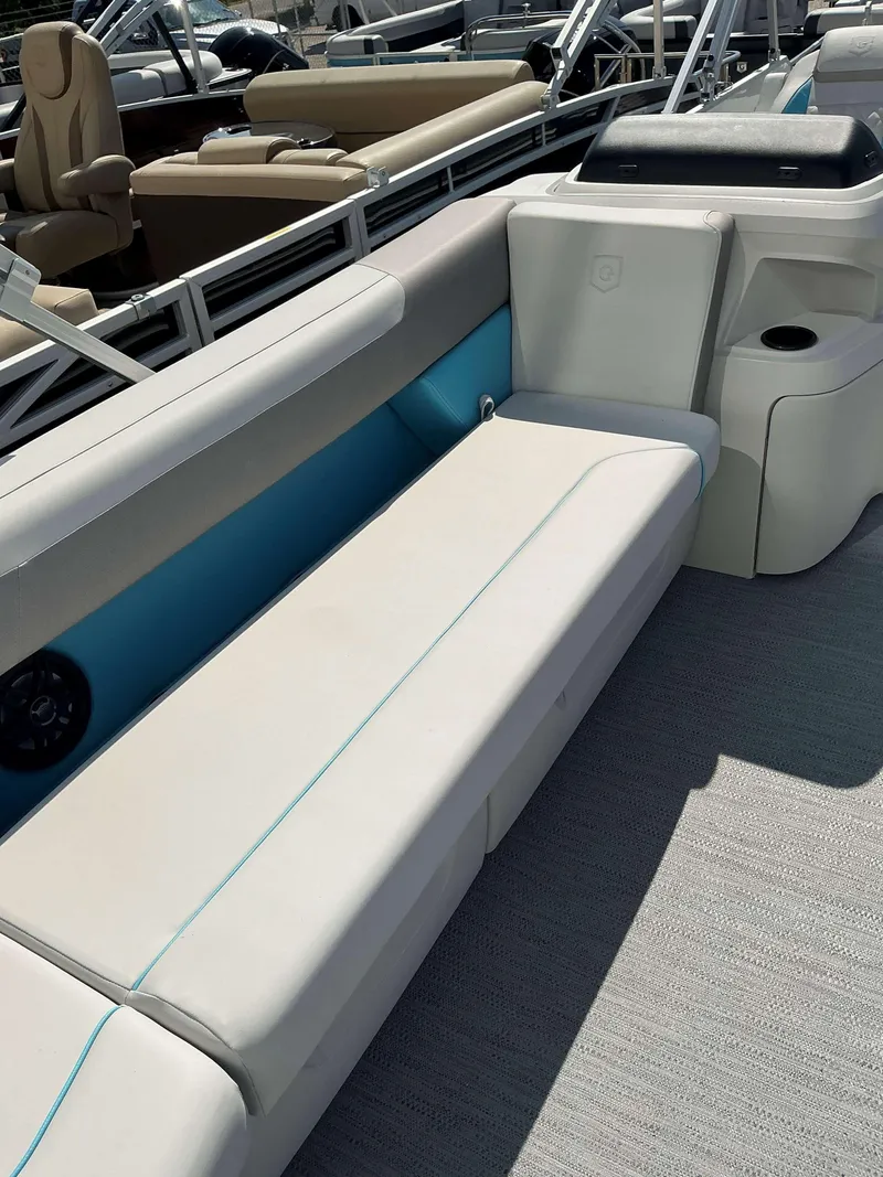 Slide: The Image of 2025 Sweetwater 2486 SFL boat interior with white seating and blue accents. - 4