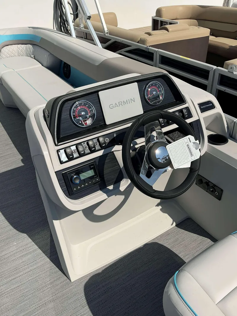 Slide: The Image of 2025 Sweetwater 2486 SFL boat dashboard with Garmin navigation system and modern controls. - 6
