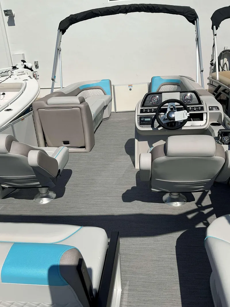 Slide: The Image of 2025 Sweetwater 2486 SFL pontoon boat interior with modern seating and steering console. - 8