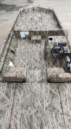 Slide: The Image of 2025 Lowe Roughneck RX1860 SC boat with camouflage design, featuring steering console and seating. - 3