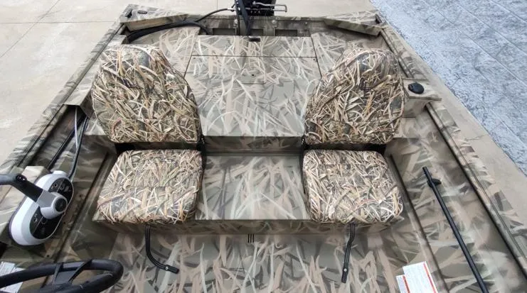 Slide: The Image of 2025 Lowe Roughneck RX1860 SC boat interior with camouflage seating and steering console. - 4