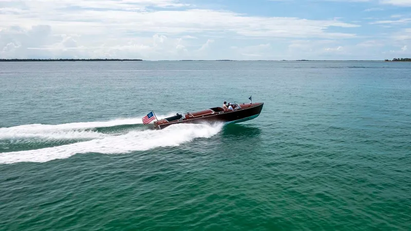 Slide: The Image of Custom 1995 Hugh Saint 34 Grand Prix speedboat cruising on open water. - 10