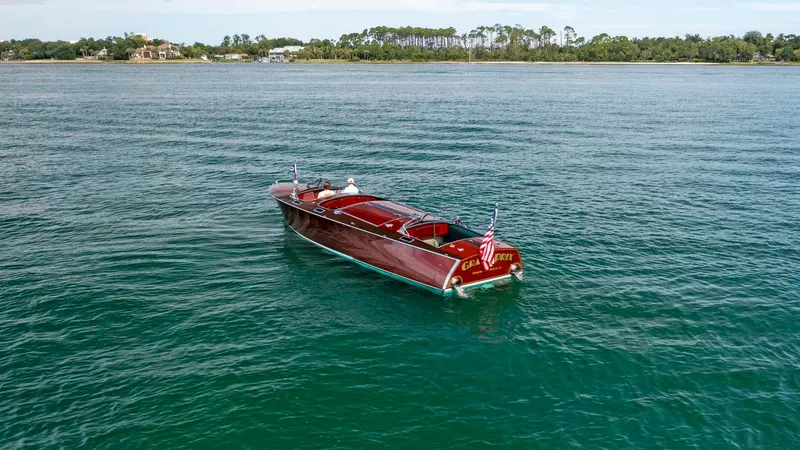 Slide: The Image of Vintage 1995 Hugh Saint 34 Grand Prix boat on serene water. - 13