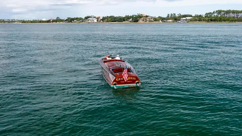 Slide: The Image of Custom 1995 Hugh Saint 34 Grand Prix boat on open water, distant shoreline view. - 14
