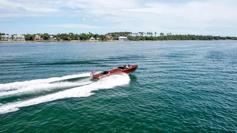Slide: The Image of Custom 1995 Hugh Saint 34 Grand Prix speedboat cruising on open water. - 15