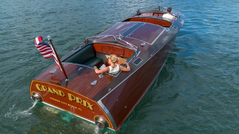 Slide: The Image of Custom 1995 Hugh Saint 34 Grand Prix boat cruising on water with American flag. - 18