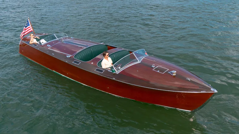 Slide: The Image of Custom 1995 Hugh Saint 34 Grand Prix boat cruising on water with American flag. - 19