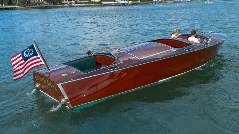 Slide: The Image of Classic 1995 Hugh Saint 34 Grand Prix boat cruising on water with American flag. - 20