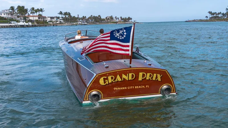 Slide: The Image of Custom 1995 Hugh Saint 34 Grand Prix boat on water, displaying American flag. - 23