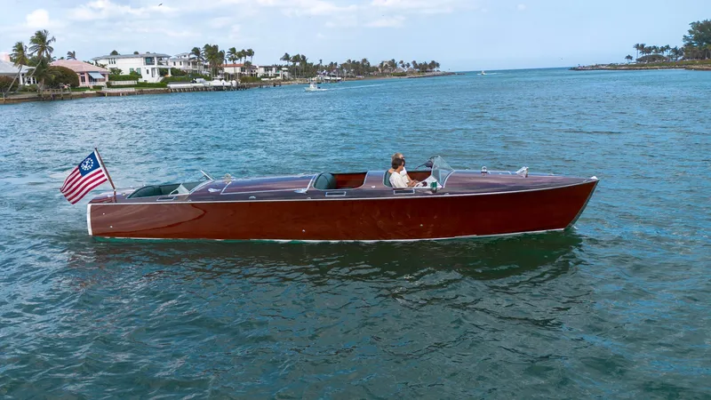 Slide: The Image of Classic 1995 Hugh Saint 34 Grand Prix boat cruising on a scenic waterway. - 24