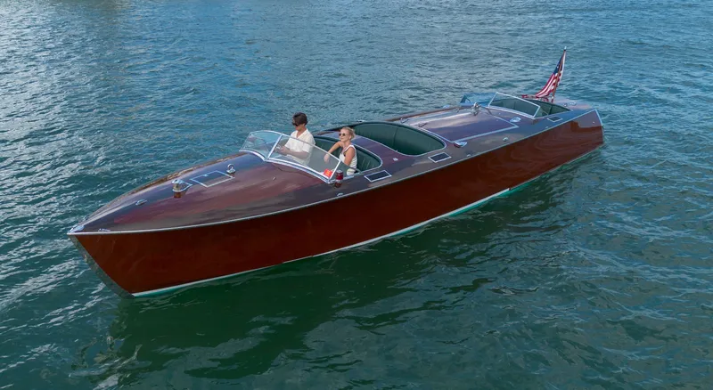 Slide: The Image of Custom 1995 Hugh Saint 34 Grand Prix boat cruising on water with American flag. - 25