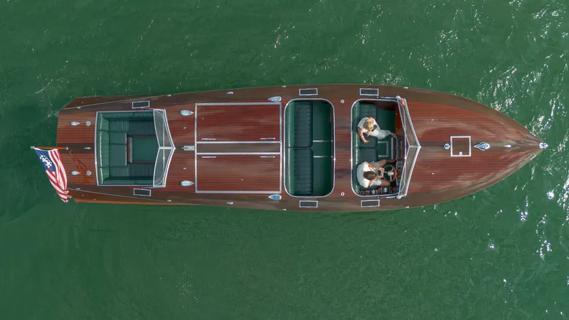 Slide: The Image of Aerial view of 1995 Custom Hugh Saint 34 Grand Prix boat on green water. - 27