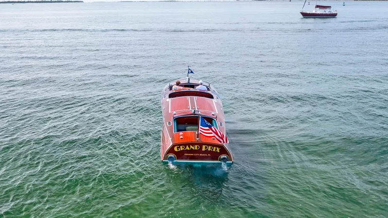 Slide: The Image of Custom 1995 Hugh Saint 34 Grand Prix boat on open water with American flag. - 3