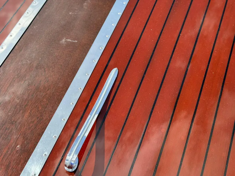 Slide: The Image of Polished wood deck of 1995 Custom Hugh Saint 34 Grand Prix boat with chrome accents. - 33