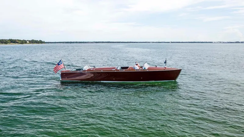 Slide: The Image of Custom 1995 Hugh Saint 34 Grand Prix boat on open water with American flag. - 5