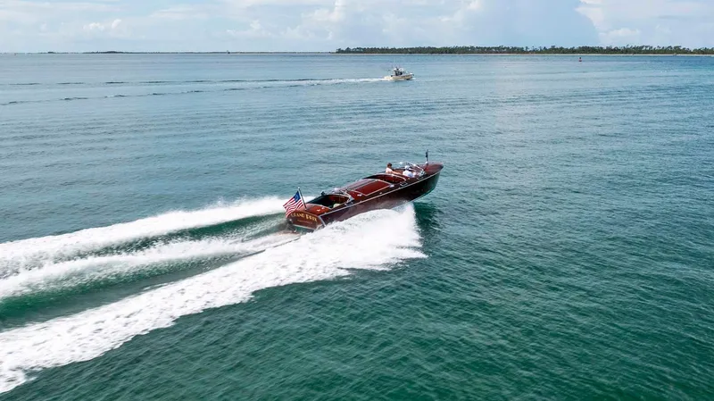 Slide: The Image of Custom 1995 Hugh Saint 34 Grand Prix boat cruising on open water. - 7