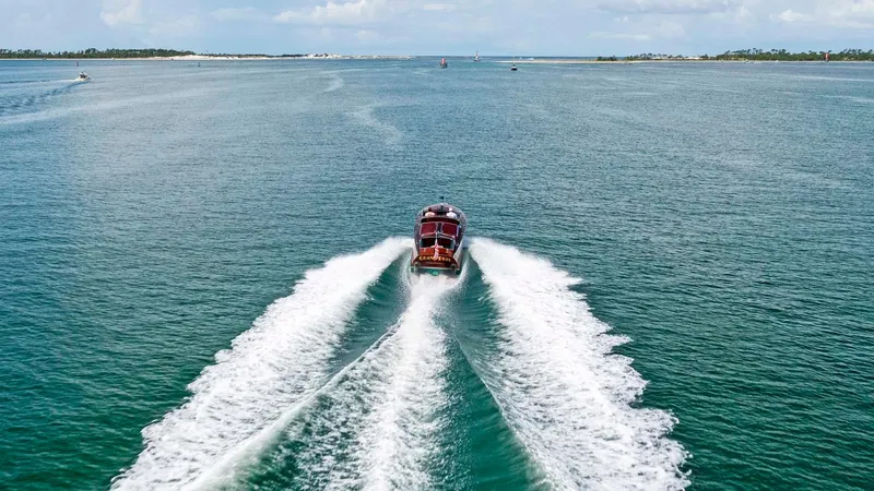 Slide: The Image of Custom 1995 Hugh Saint 34 Grand Prix boat cruising on open water. - 8