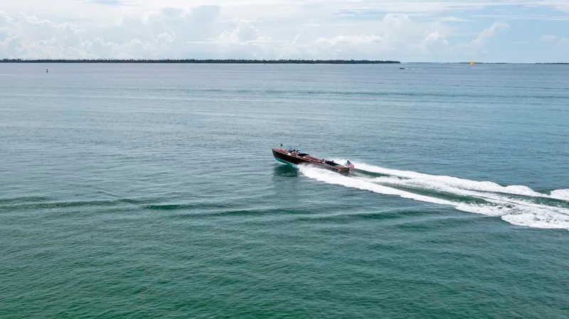 Slide: The Image of Custom 1995 Hugh Saint 34 Grand Prix boat cruising on open water. - 9