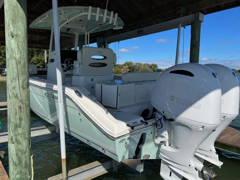 Slide: The Image of 2021 Cobia 240 Center Console boat with Yamaha engines on a lift. - 4