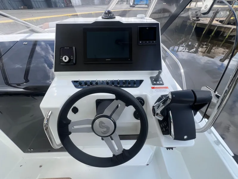 Slide: The Image of 2025 Beneteau Flyer 9 SUNdeck helm with modern controls and navigation display. - 10