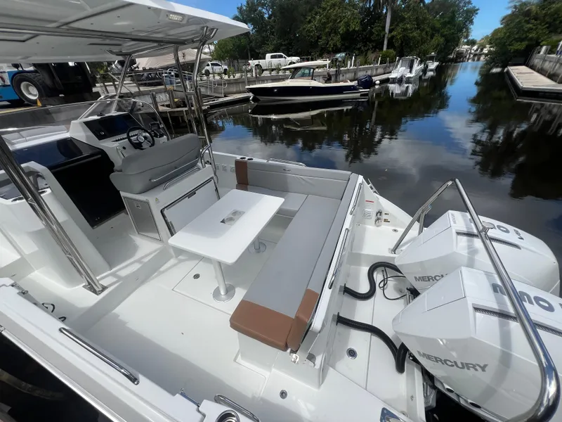 Slide: The Image of 2025 Beneteau Flyer 9 SUNdeck with Mercury engines, docked in a serene marina setting. - 14