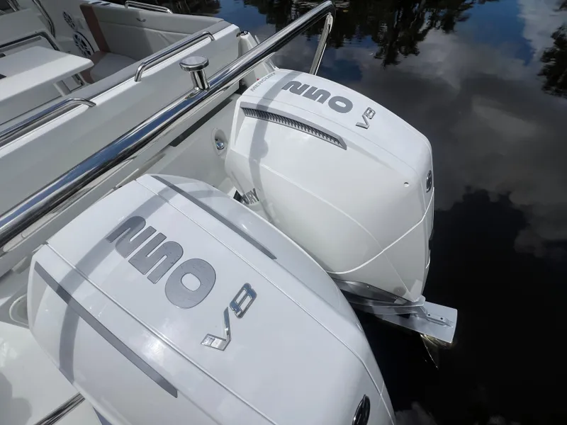 Slide: The Image of 2025 Beneteau Flyer 9 SUNdeck with dual outboard engines on calm water. - 16