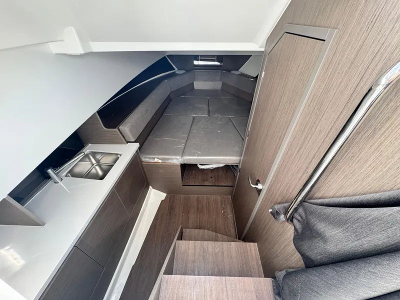 Slide: The Image of 2024 Beneteau Flyer 9 SUNdeck interior with kitchenette and seating area. - 17