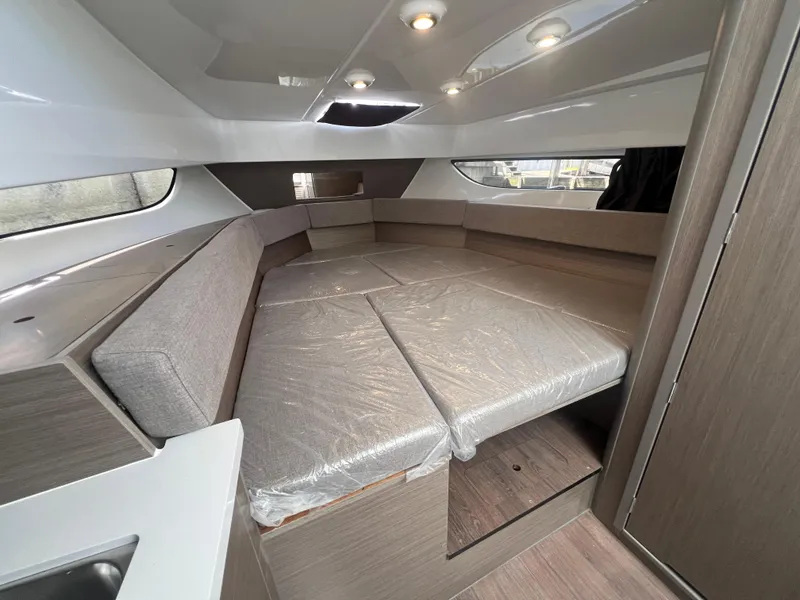 Slide: The Image of 2025 Beneteau Flyer 9 SUNdeck cabin interior with modern seating and lighting. - 18
