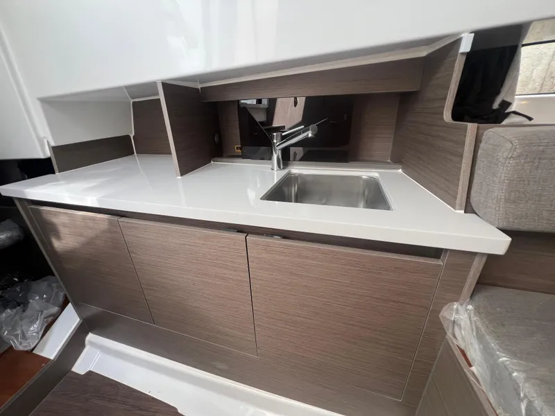 Slide: The Image of 2025 Beneteau Flyer 9 SUNdeck interior kitchen with modern sink and cabinetry. - 19