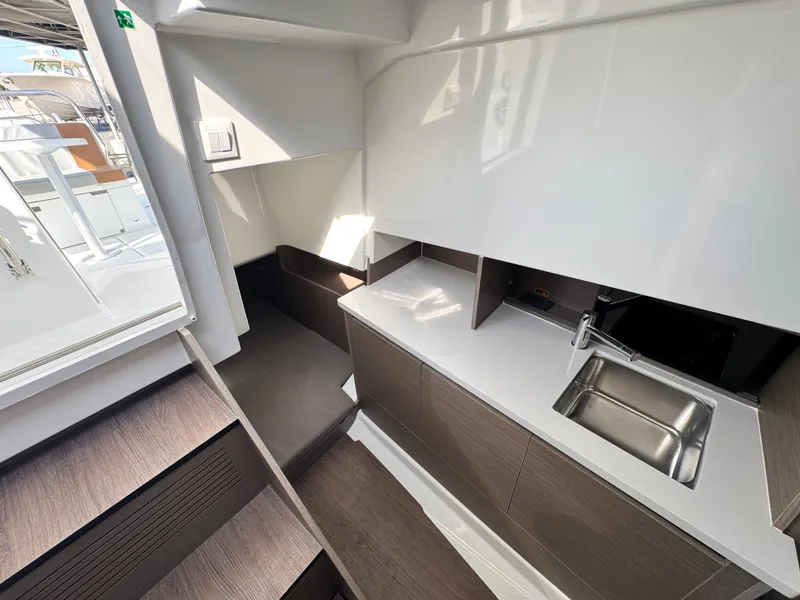 Slide: The Image of 2024 Beneteau Flyer 9 SUNdeck interior with modern kitchenette and sleek design. - 20