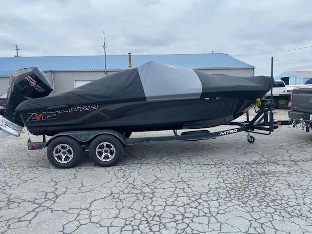Slide: The Image of 2023 Nitro ZV19 Pro boat covered on trailer, parked on cracked pavement. - 9