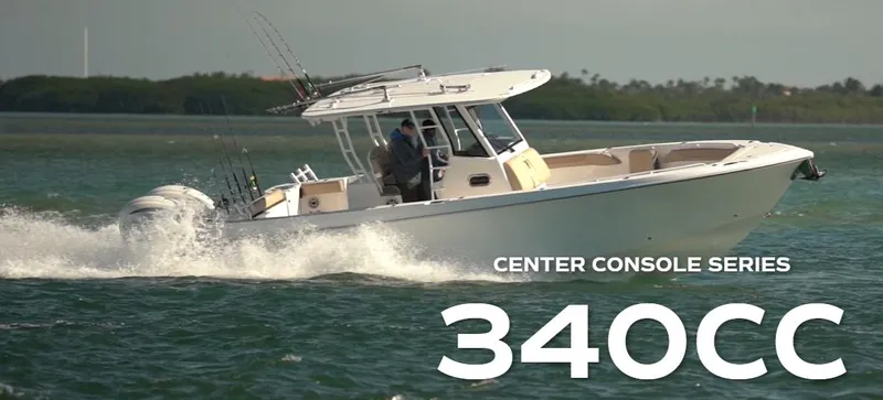 Slide: The Image of 2025 Edgewater 340CC boat cruising on open water, center console series. - 1