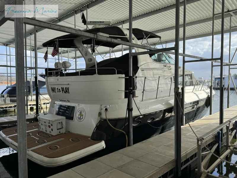 Slide: The Image of 2001 Cruisers Yachts 4450 Express Motoryacht docked in a covered marina. - 15