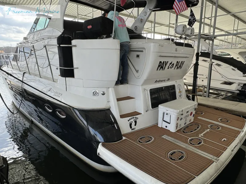 Slide: The Image of 2001 Cruisers Yachts 4450 Express Motoryacht docked in marina, rear view. - 17