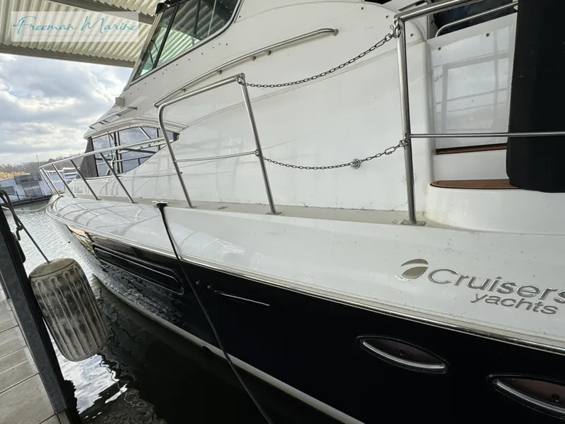 Slide: The Image of 2001 Cruisers Yachts 4450 Express Motoryacht docked at marina. - 19