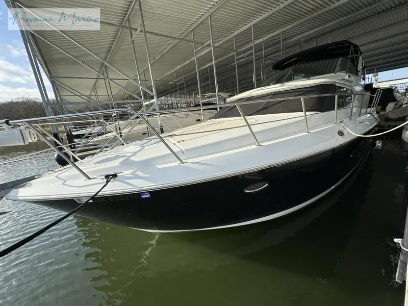 Slide: The Image of 2001 Cruisers Yachts 4450 Express Motoryacht docked in covered marina. - 22