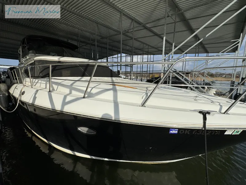 Slide: The Image of 2001 Cruisers Yachts 4450 Express Motoryacht docked in covered marina. - 26