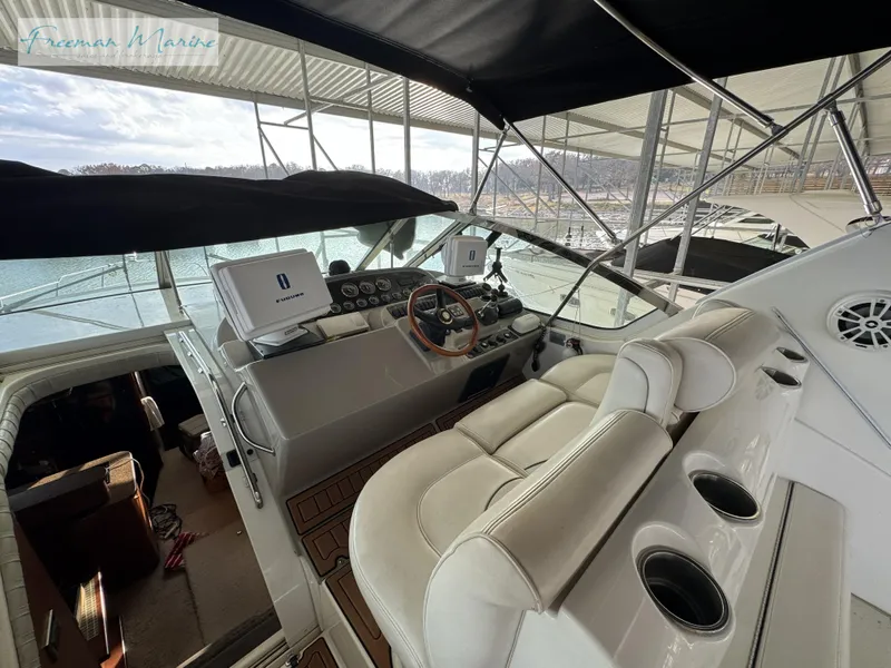 Slide: The Image of 2001 Cruisers Yachts 4450 Express Motoryacht helm with leather seating and navigation equipment. - 29