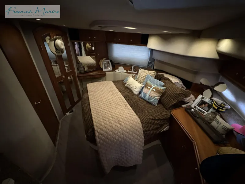Slide: The Image of Luxurious bedroom interior of 2001 Cruisers Yachts 4450 Express Motoryacht, featuring cozy bedding and elegant decor. - 34