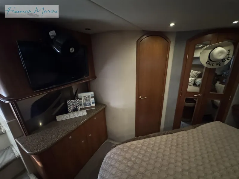 Slide: The Image of Luxurious 2001 Cruisers Yachts 4450 Express Motoryacht interior bedroom with TV and decor. - 35