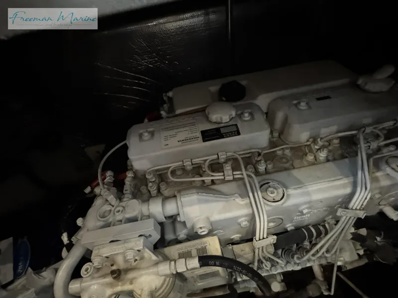 Slide: The Image of Engine of 2001 Cruisers Yachts 4450 Express Motoryacht in a dimly lit compartment. - 46