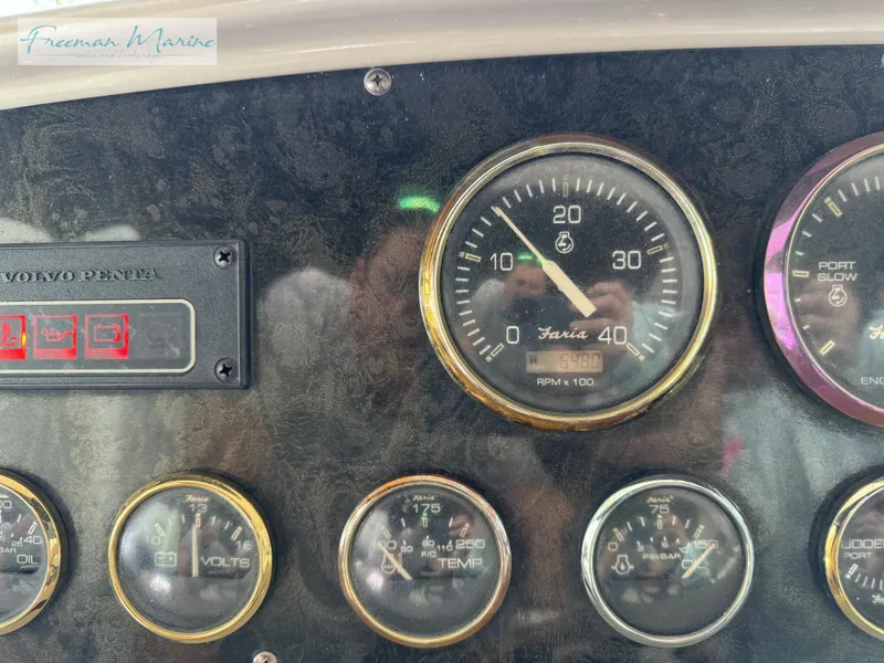 Slide: The Image of Dashboard of 2001 Cruisers Yachts 4450 Express Motoryacht with various gauges and controls. - 48